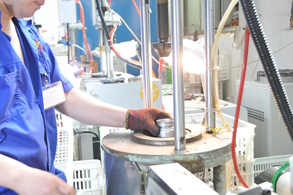 Workers operating stainless steel bottle production equipment in Jianyang factory